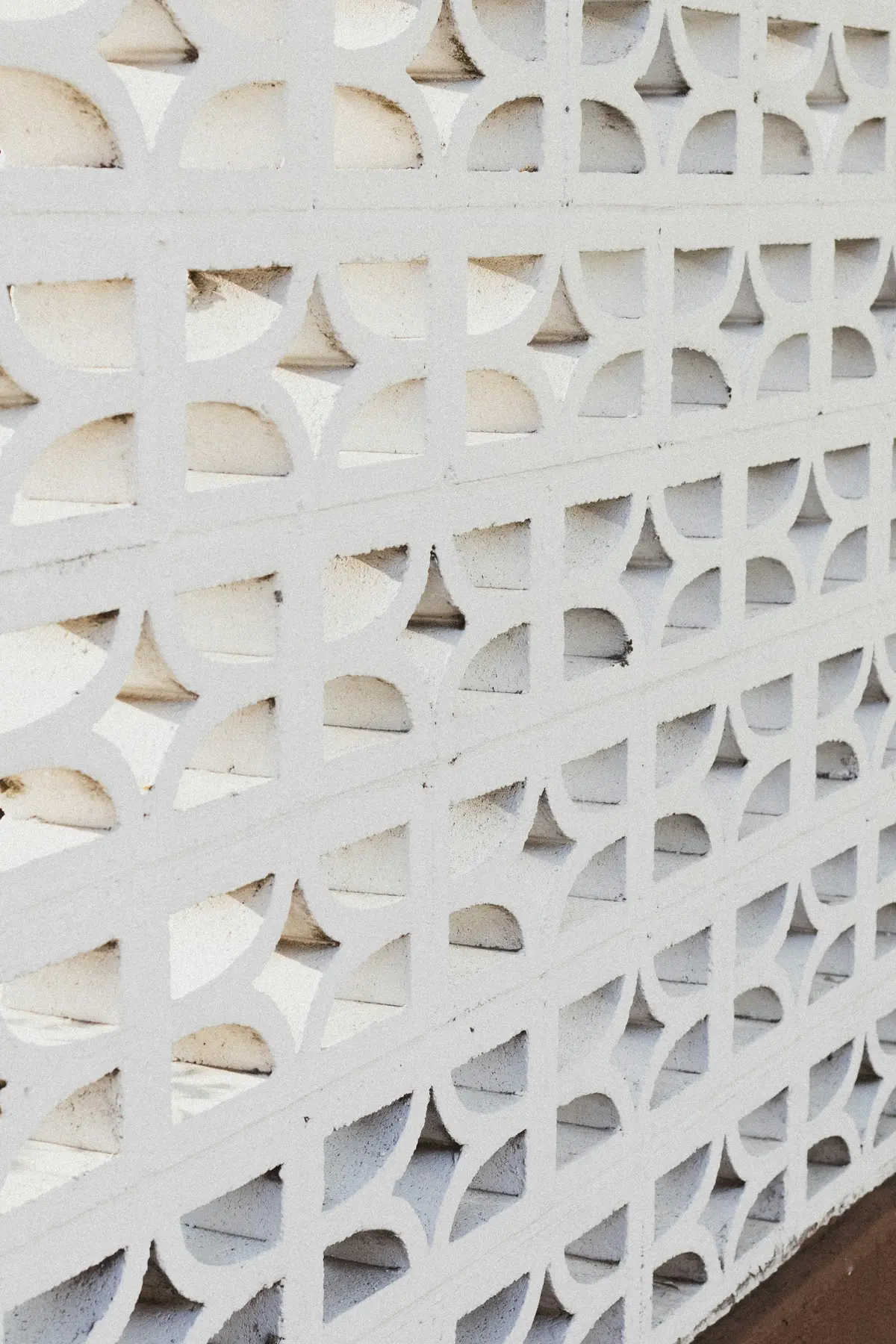 A white breeze-block wall in the sun