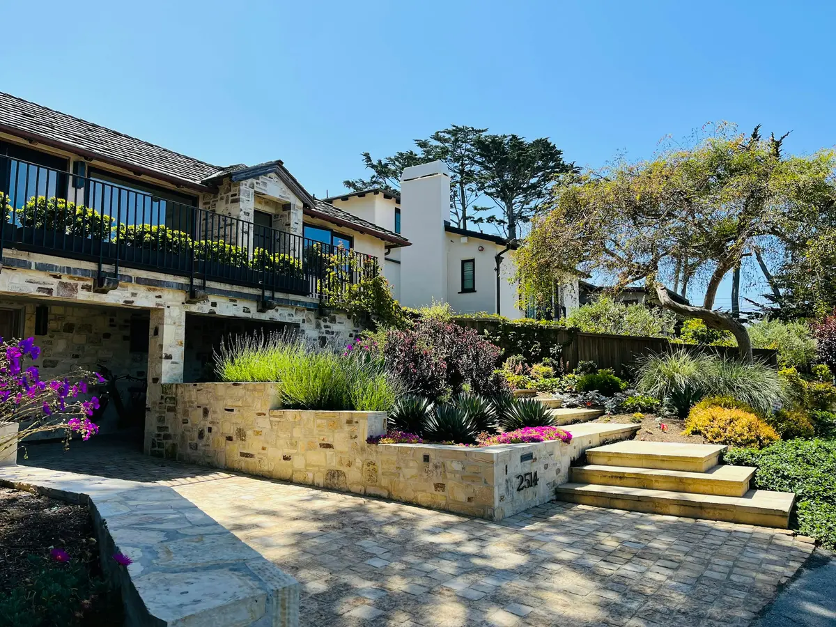 A hillside house above terraced gardens and stone steps