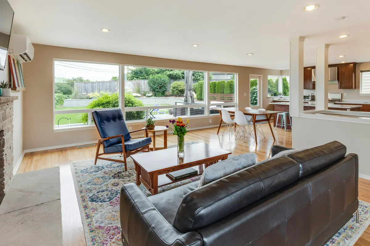 A living room with leather sofas and big windows