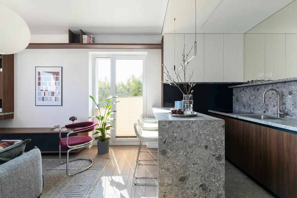 Kitchen with a stone island and an open living area
