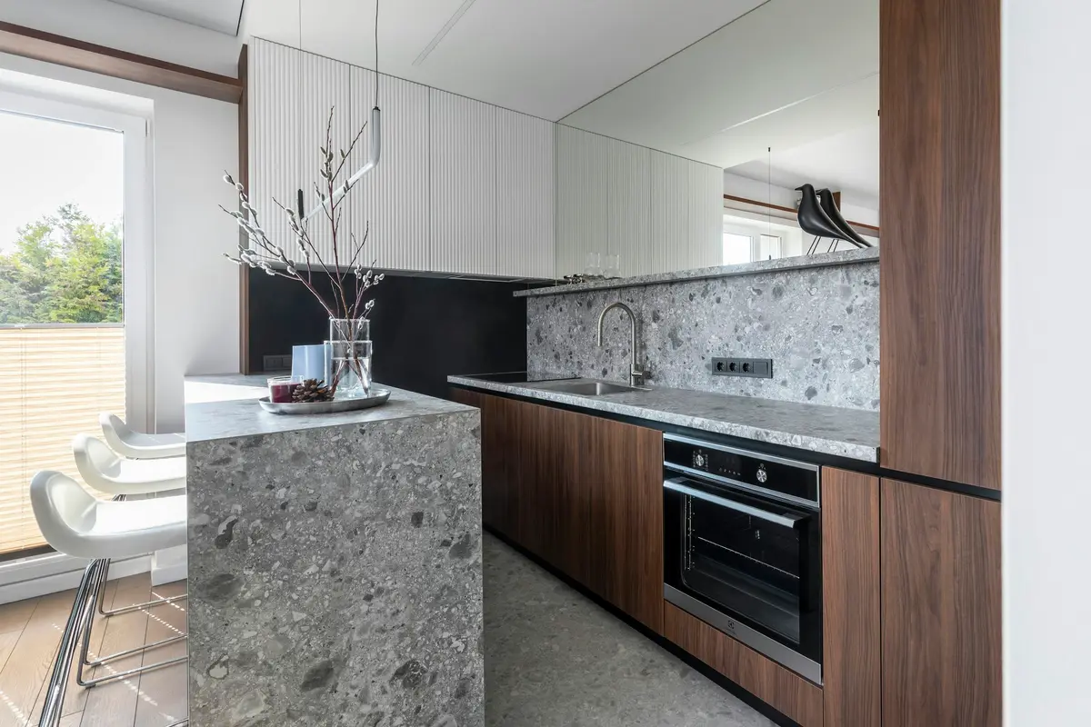 Kitchen with terrazzo counters and walnut cabinets