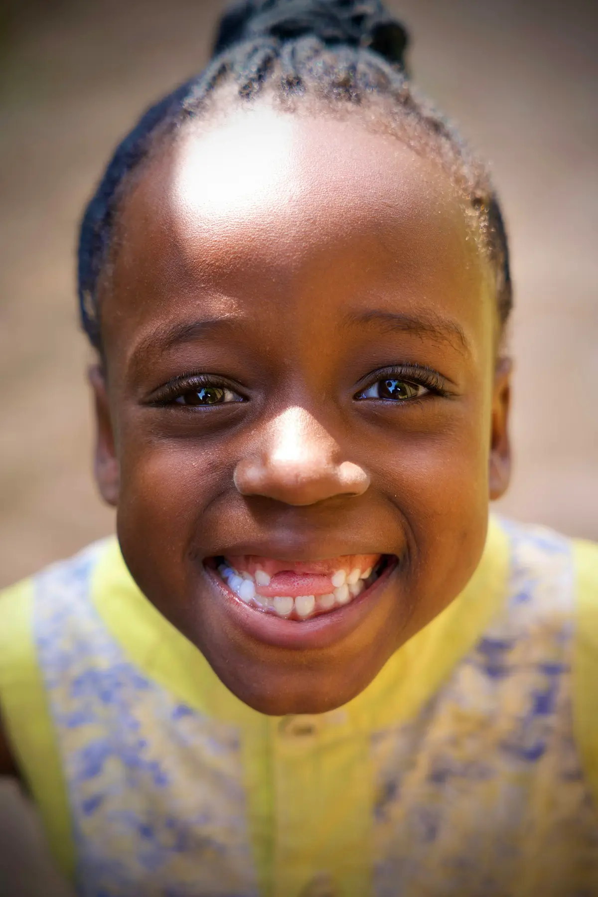 A young girl with a gap-toothed smile