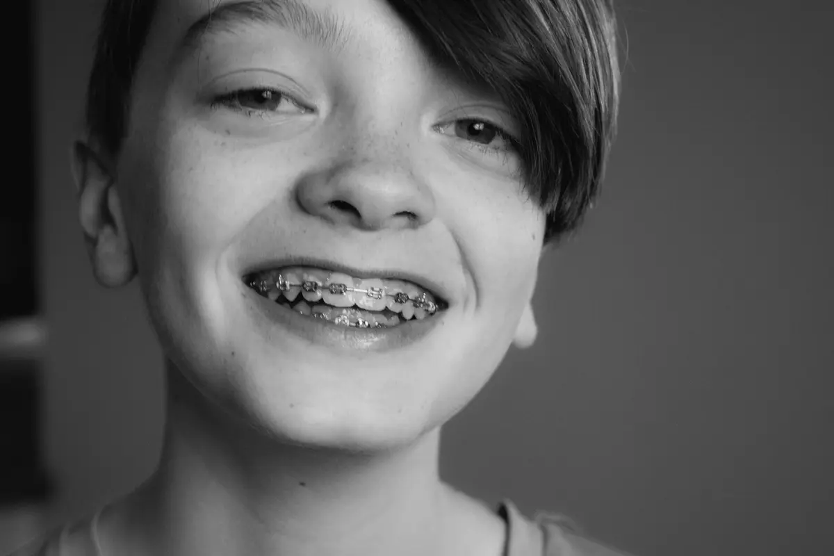 A teenager smiling with braces
