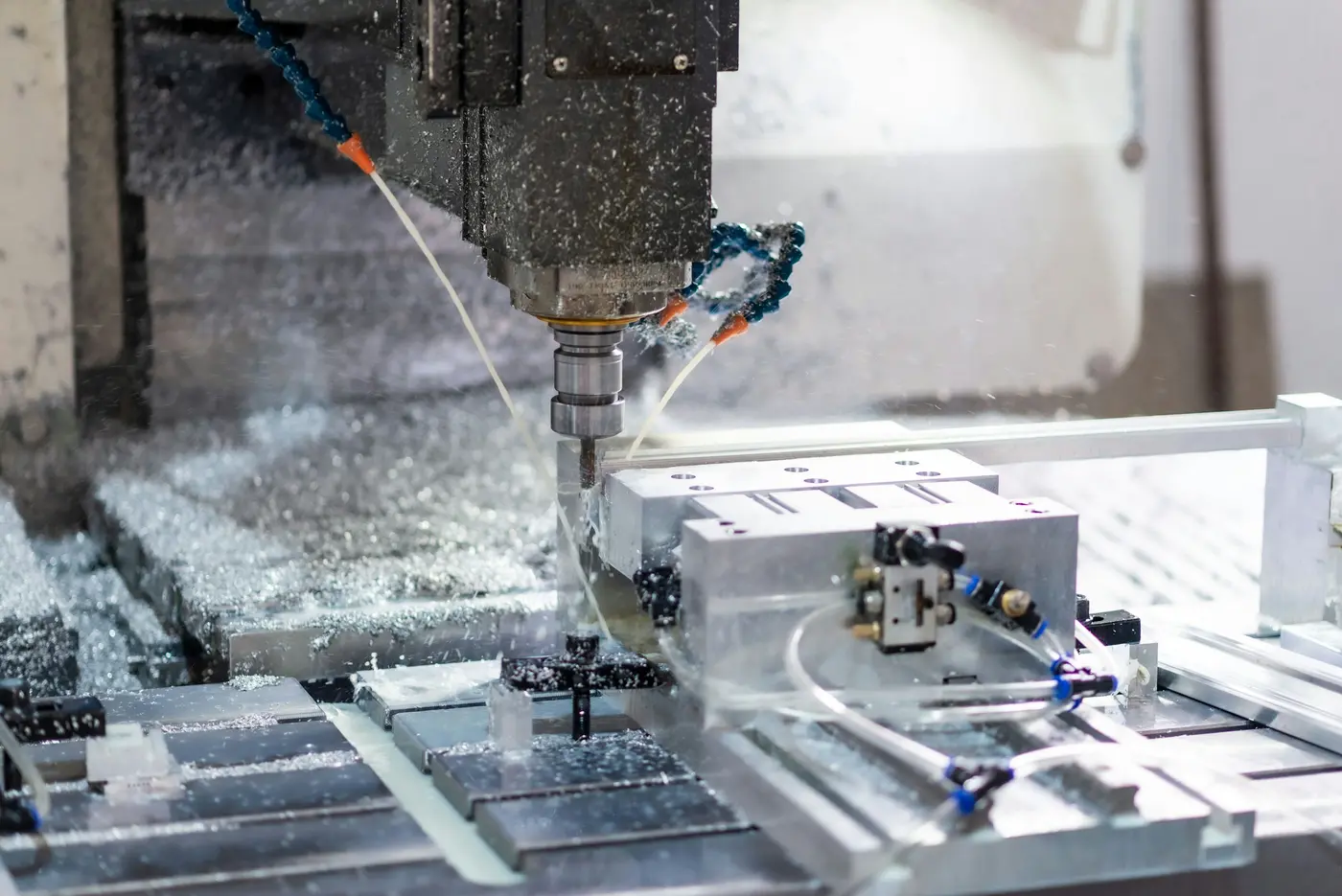 A CNC mill cutting a metal part